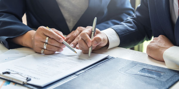 Signing Contracts. A Group Of Business People Sign A Joint Inves
