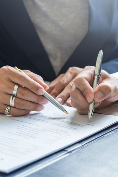 Signing Contracts. A Group Of Business People Sign A Joint Inves